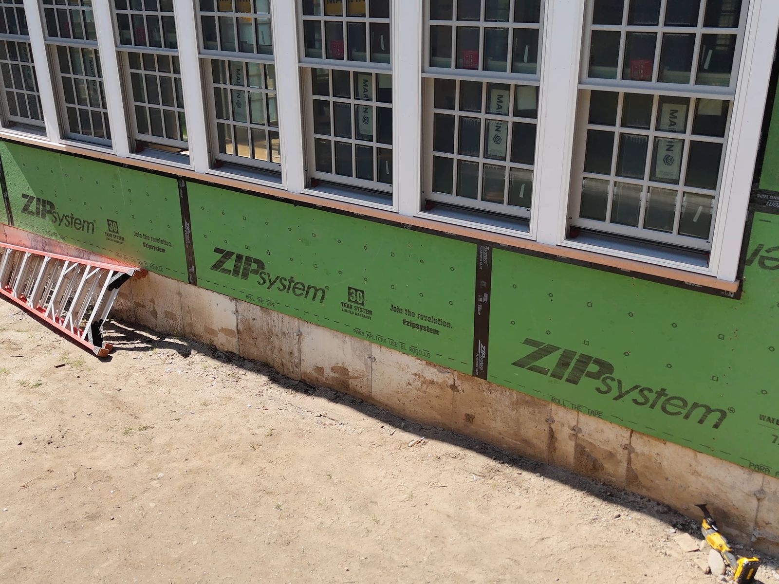 Addition walls sealed with ZIP sheathing before siding