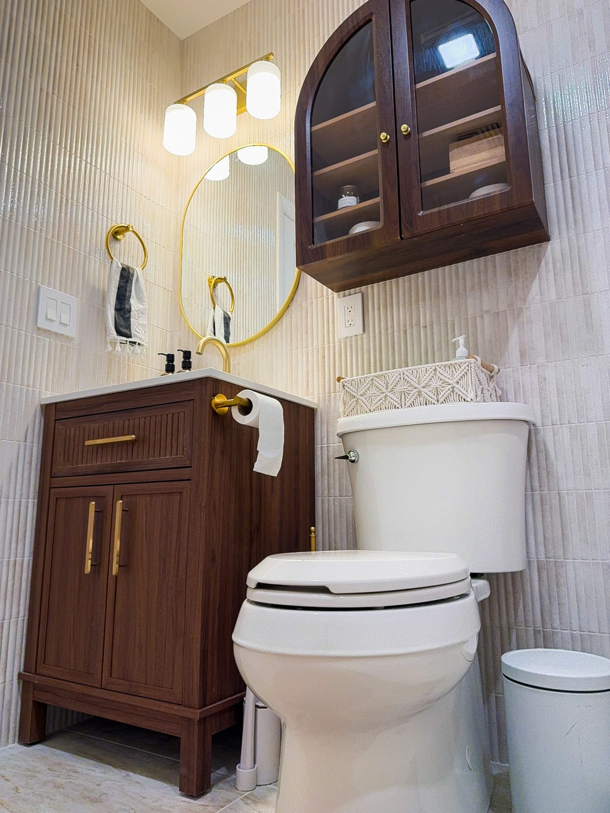 Close-up of the fluted wood vanity with brushed-gold pulls and faucet