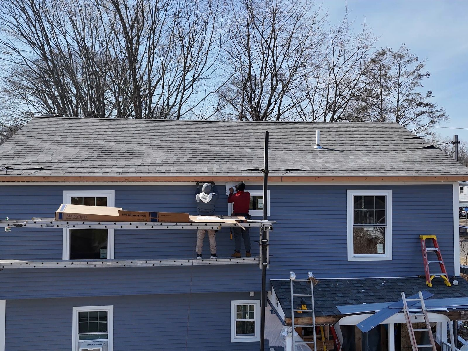 New blue siding going on the back of the house