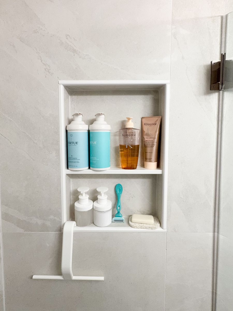 Recessed shower niche with a built-in shelf