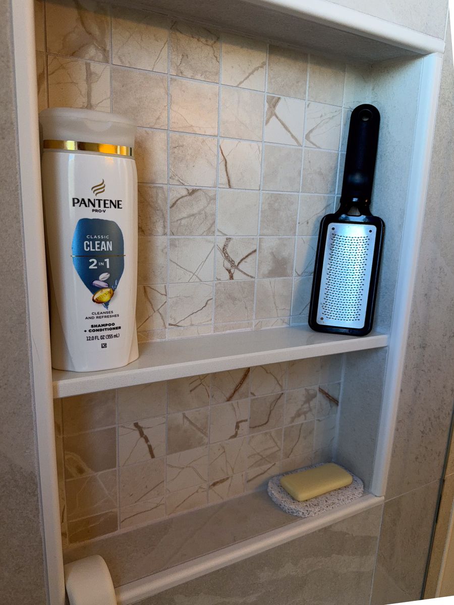 Two-shelf recessed shower niche with marble-look mosaic back